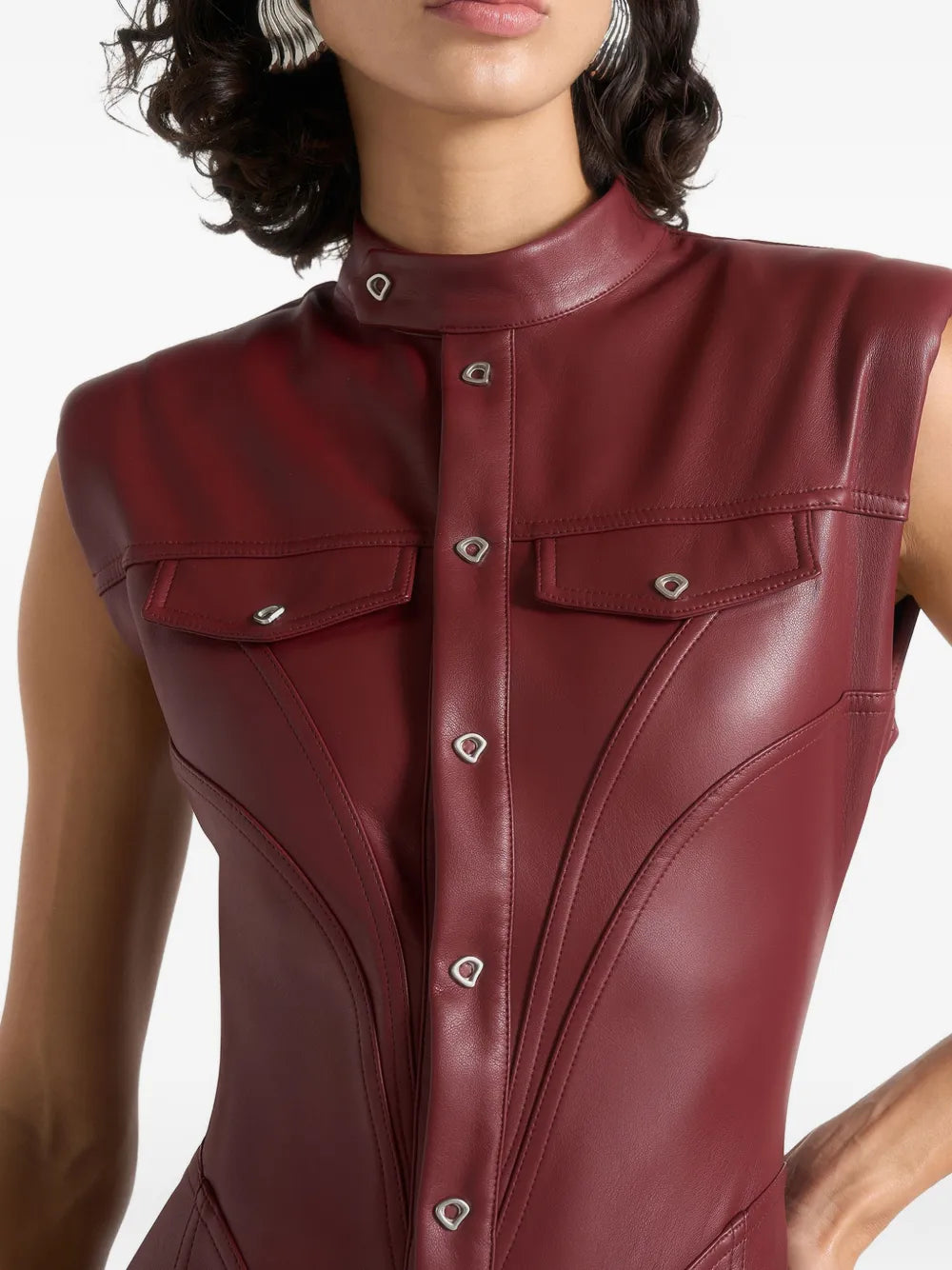 Aurelia Luxe women's deep burgundy maroon genuine lambskin leather jumpsuit featuring a high mandarin stand collar, cap shoulders, full-length front snap button placket, dual chest flap pockets, waist-contouring vertical seams, flared bootcut legs, and custom made-to-measure fitting across the UK, USA, and Australia.1