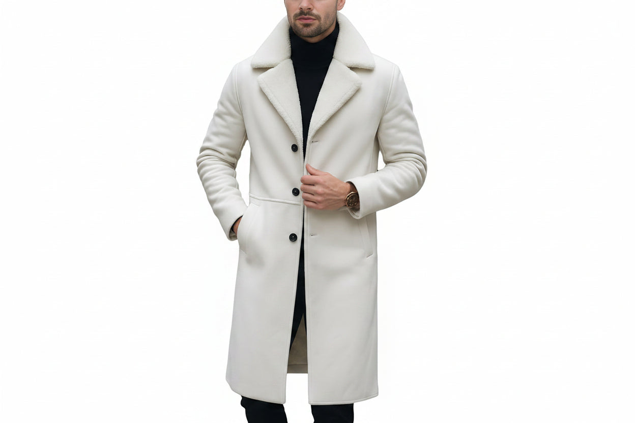 Men's black crest rugged genuine soft lambskin real leather overcoat in off-white ivory featuring broad plush shearling fur notch lapels, single-breasted dark button front closure, side slant welt pockets, long fitted sleeves, knee-length fit, and custom made-to-measure fitting across the UK, USA, and Australia.