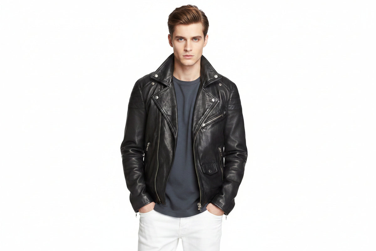 Men's Classic genuine real soft lambskin leather biker jacket in sleek jet black featuring wide notch lapels with silver press-stud snaps, asymmetrical off-center front zipper closure, ribbed channel-quilted shoulder panels, sloped zip chest pocket, zip hand pockets, snap-flap coin pocket, side waist cinch buckles, zippered sleeve cuffs, tailored slim fit, and custom made-to-measure tailoring available worldwide.