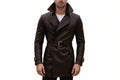 Men's crest mark minimalist genuine soft lambskin real leather long trench coat in dark espresso brown featuring an exaggerated high stand collar, wide notch lapels, double-breasted button front closure, matching waist belt with metallic silver buckle, flap pockets, buckled sleeve cuffs, long fitted sleeves, mid-thigh length cut, and custom made-to-measure fitting across the UK, USA, and Australia.