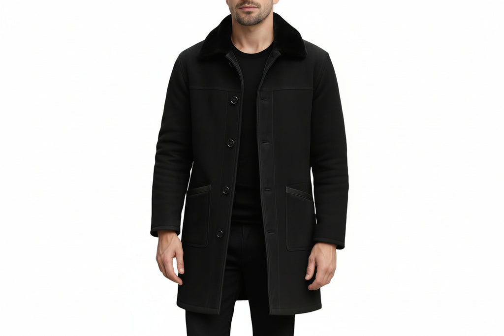 Men's crown edge elegant genuine soft suede real leather long coat in jet black featuring a plush tonal black fur fold-over collar, single-breasted button front closure, large hip patch pockets, long fitted sleeves, knee-length cut, and custom made-to-measure fitting across the UK, USA, and Australia.