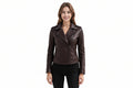 A woman modeling a dark brown faux leather moto jacket with an asymmetrical zipper, set against a plain white background.