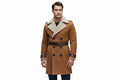 Men's elite stag formal wear genuine soft suede real leather long coat in chestnut tan featuring a wide plush cream shearling fleece lapel collar, contrast dark brown leather waist belt trim, single-breasted button front closure, curved front side pockets, matching dark leather cuff bands, long fitted sleeves, thigh-length cut, and custom made-to-measure fitting across the UK, USA, and Australia.