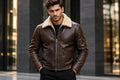 Front view of a man wearing the brown Ghost Forge Suave Lambskin Men's Club Leather Jacket featuring a plush contrast shearling collar. 