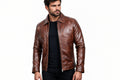 Front view of a man wearing the antique brown Ghost Wolf Statement Biker Leather Jacket featuring a spread collar and full-zip front.