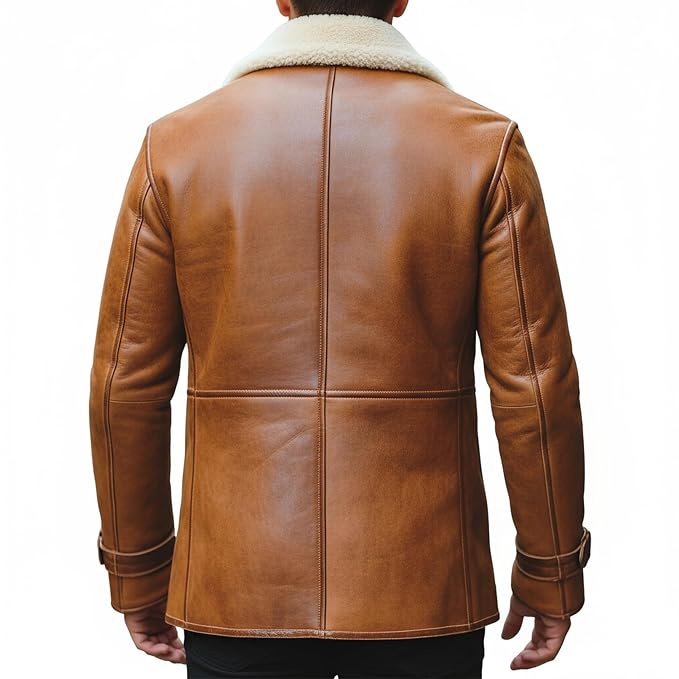 Men's grand thread adventure style genuine soft lambskin real leather long coat in burnished tan featuring a plush wide cream shearling fleece collar and notch lapels, dark brown leather piping trim, single-breasted button front closure, deep angled side handwarmer pockets, buckled sleeve cuff straps, long fitted sleeves, mid-to-thigh length cut, and custom made-to-measure fitting across the UK, USA, and Australia.back
