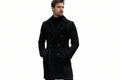 Men's imperial thread stylish tailored fit genuine soft suede real leather long coat in matte jet black featuring broad double-breasted notch lapels, multi-button front closure, vertical waist-contouring seams, slanted side handwarmer welt pockets, long fitted sleeves, knee-length cut, and custom made-to-measure fitting across the UK, USA, and Australia.