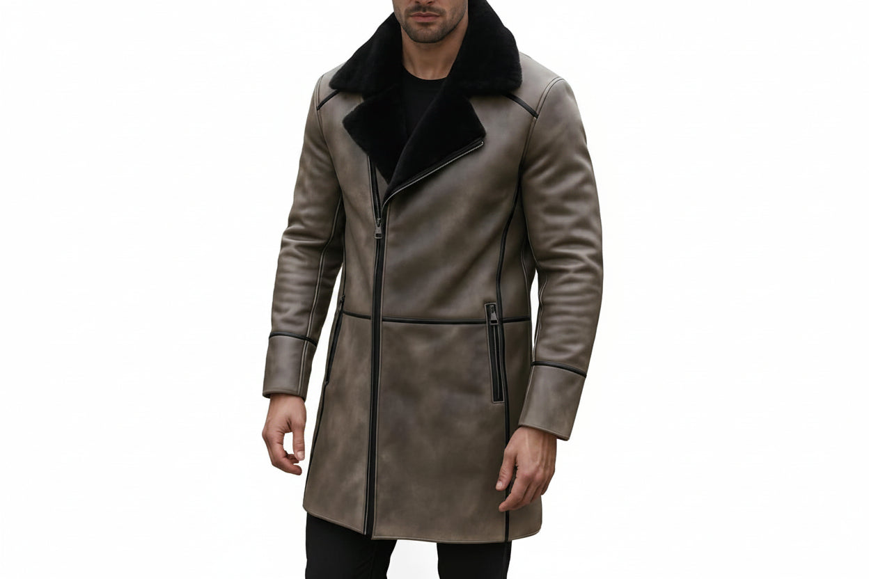 Men's iron blazer longline vintage genuine soft nappa real leather coat in distressed taupe grey featuring a contrasting plush wide black shearling fleece collar, asymmetrical diagonal zip front closure, black leather seam piping trim on shoulders and cuffs, vertical metal zippered side pockets, mid-thigh length cut, and custom made-to-measure fitting across the UK, USA, and Australia.