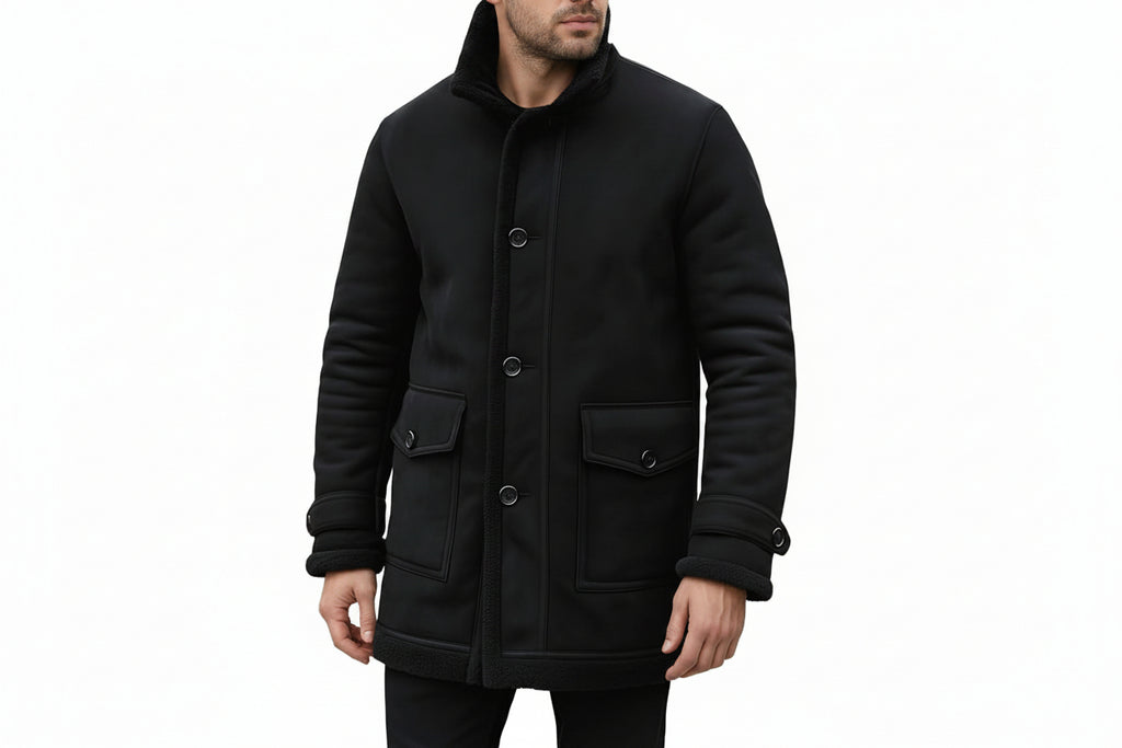 Men's luxe knight vintage genuine soft suede real leather 3/4 length long coat in jet black featuring a plush integrated black shearling fleece stand collar and lining, single-breasted button front closure with shearling edge trim, large buttoned flap front utility pockets, adjustable wrist cuff straps with shearling trim, mid-thigh length cut, and custom made-to-measure fitting across the UK, USA, and Australia.