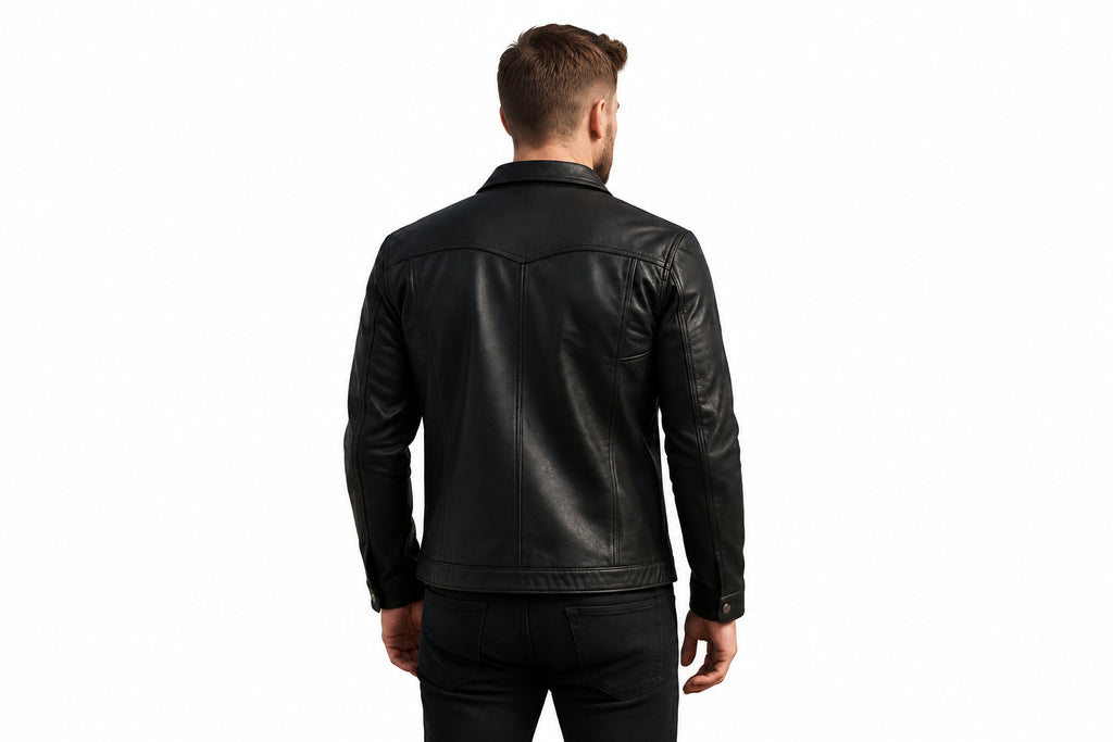 Back view of a man wearing the black Night Pelt Distressed Lambskin Cafe Racer Leather Jacket featuring a shirt collar, button closure, and utility chest pockets.   