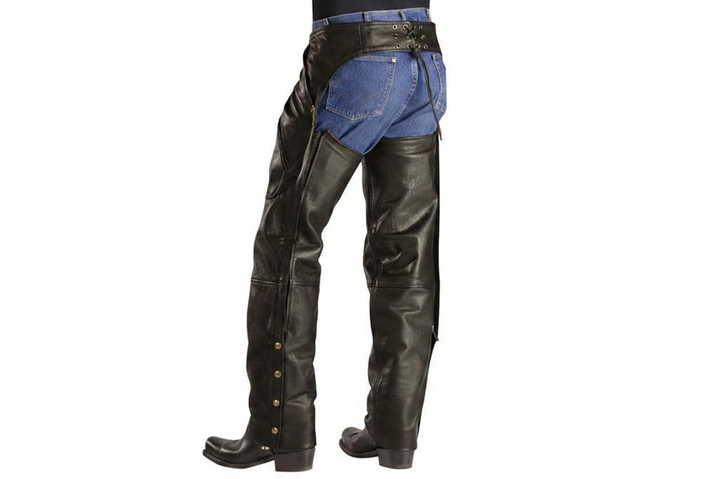 Black leather chaps with snap-button details down the front of the legs, worn over blue denim jeans, shown from a rear three-quarter view on a white background.