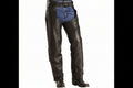 Black leather motorcycle chaps worn over blue jeans, featuring a belt with silver studs and black leather chaps boots, shown against a plain white background.