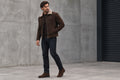 Side view of a man wearing the dark brown Prestige Hide Heritage Biker Mens Suede Leather Jacket featuring a shearling collar and zip closure.