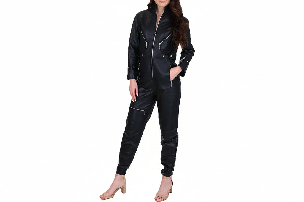 Ravenelle women's jet black genuine lambskin leather jumpsuit featuring a high stand collar, full-length front silver zip closure, slanted zipper chest and thigh pockets, snap waist tabs, zippered ankle hems, and custom made-to-measure fitting across the UK, USA, and Australia.