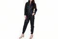 Ravenelle women's jet black genuine lambskin leather jumpsuit featuring a high stand collar, full-length front silver zip closure, slanted zipper chest and thigh pockets, snap waist tabs, zippered ankle hems, and custom made-to-measure fitting across the UK, USA, and Australia.
