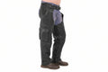 Men's rebel hide tactical genuine soft lambskin real leather motorcycle riding chaps in black featuring stretch-accordion ribbed elastic hip panels, adjustable front belt buckle, right thigh multi-pocket utility layout with horizontal zipper and flap cargo pocket, full-length side leg zippers, lower ankle snap-button closures, open crotch over-jeans design, and custom made-to-measure fitting across the UK, USA, and Australia.