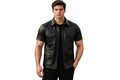 Front view of a man wearing the black short-sleeve Rogue Edge Lambskin Modern Luxe Bomber Jacket featuring a shirt collar and utility pockets.