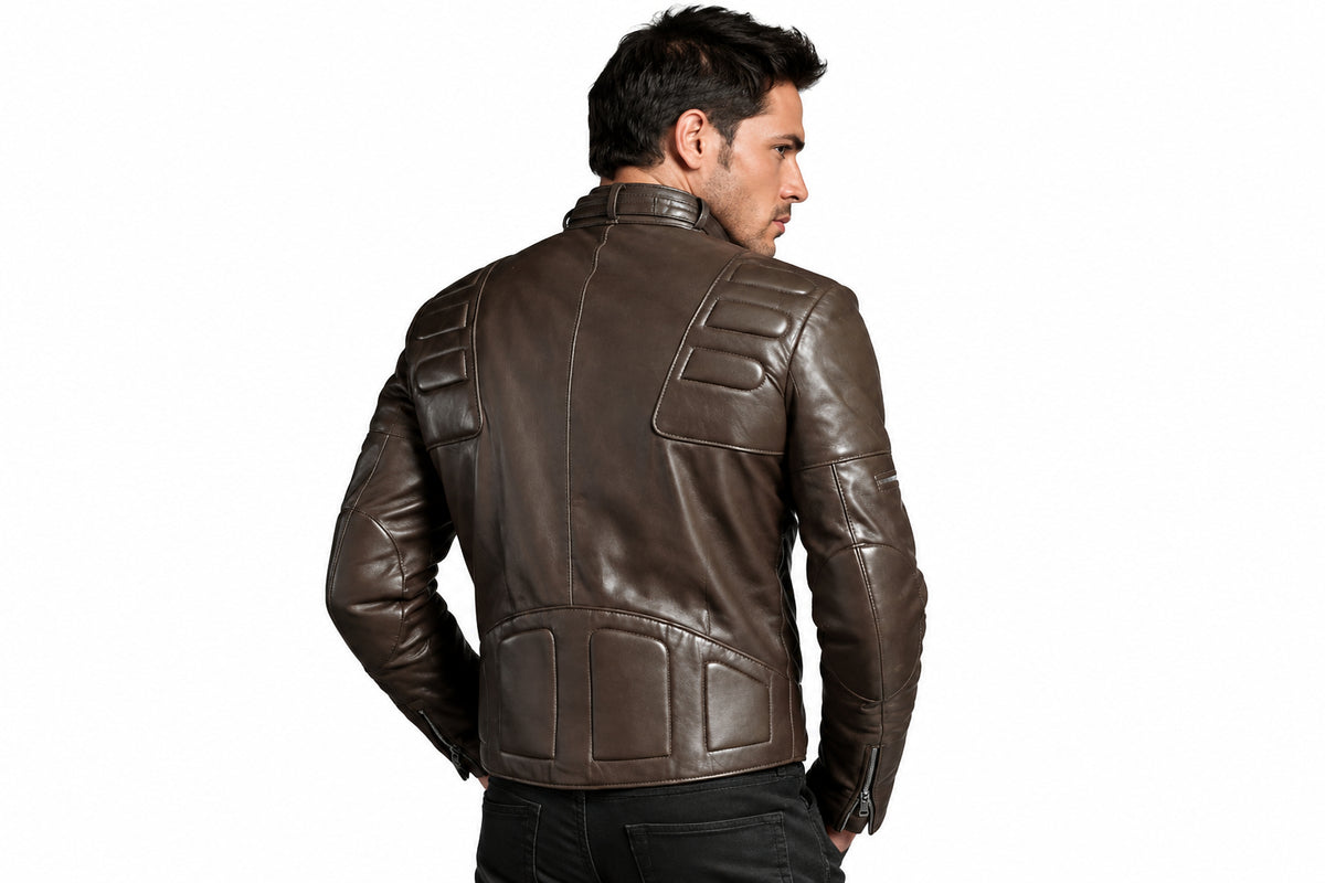Back view of a man wearing the dark brown Shadowline Asymmetrical Moto Jacket featuring a snap-tab collar, offset zipper, and quilted shoulder padding.