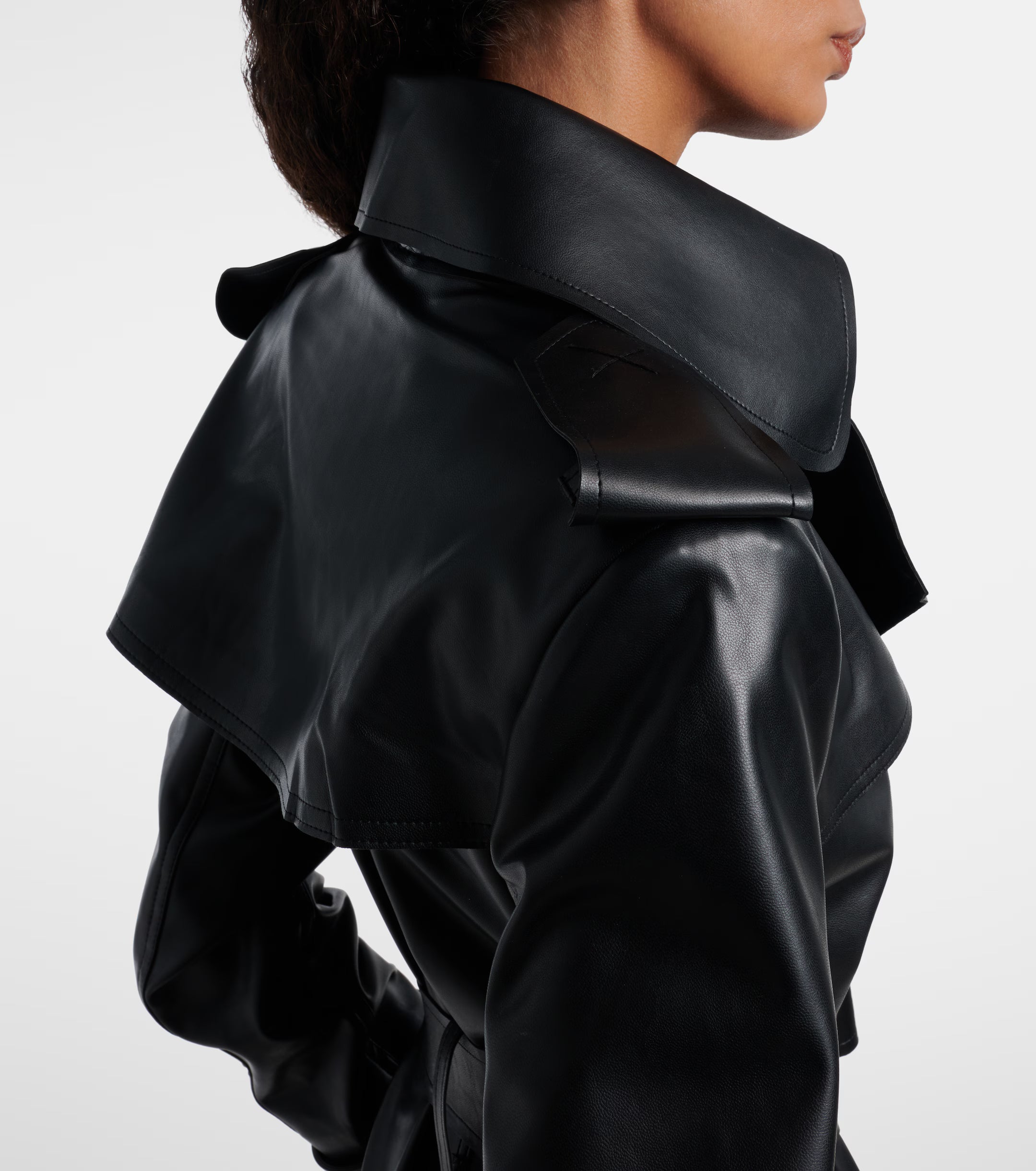 Sienna Noir women's jet black genuine Nappa lambskin leather jumpsuit featuring a trench coat style notch collar, chest storm flap, shoulder epaulettes, self-tie leather waist belt, wide-leg trousers, and custom made-to-measure fitting across the UK, USA, and Australia.side