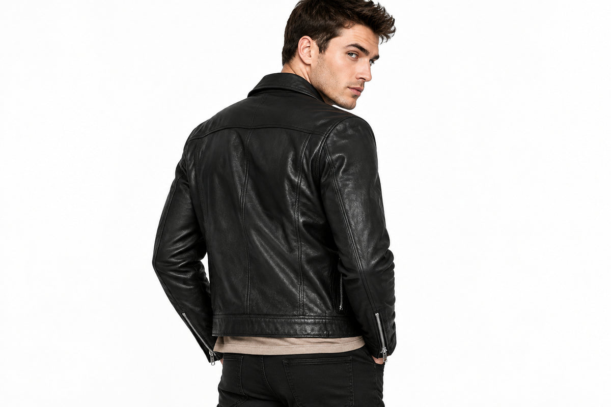 Back view of a man wearing the black Sleek & Minimalist Cafe Racers Jacket featuring a stand collar and full-zip front closure.