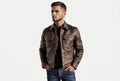 Front view of a man wearing the brown Storm Trail Luxe Legacy Real Leather Racer Jacket featuring dual chest pockets and a shirt collar.