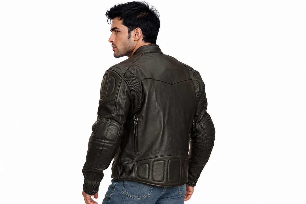 Back view of a man wearing the black The Bespoke Atelier Biker Jacket featuring a snap-tab collar and multi-zip layout.