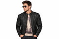 Front view of a man wearing the charcoal black The Cyber-Rider Biker Jacket featuring a snap-tab collar and full-zip closure