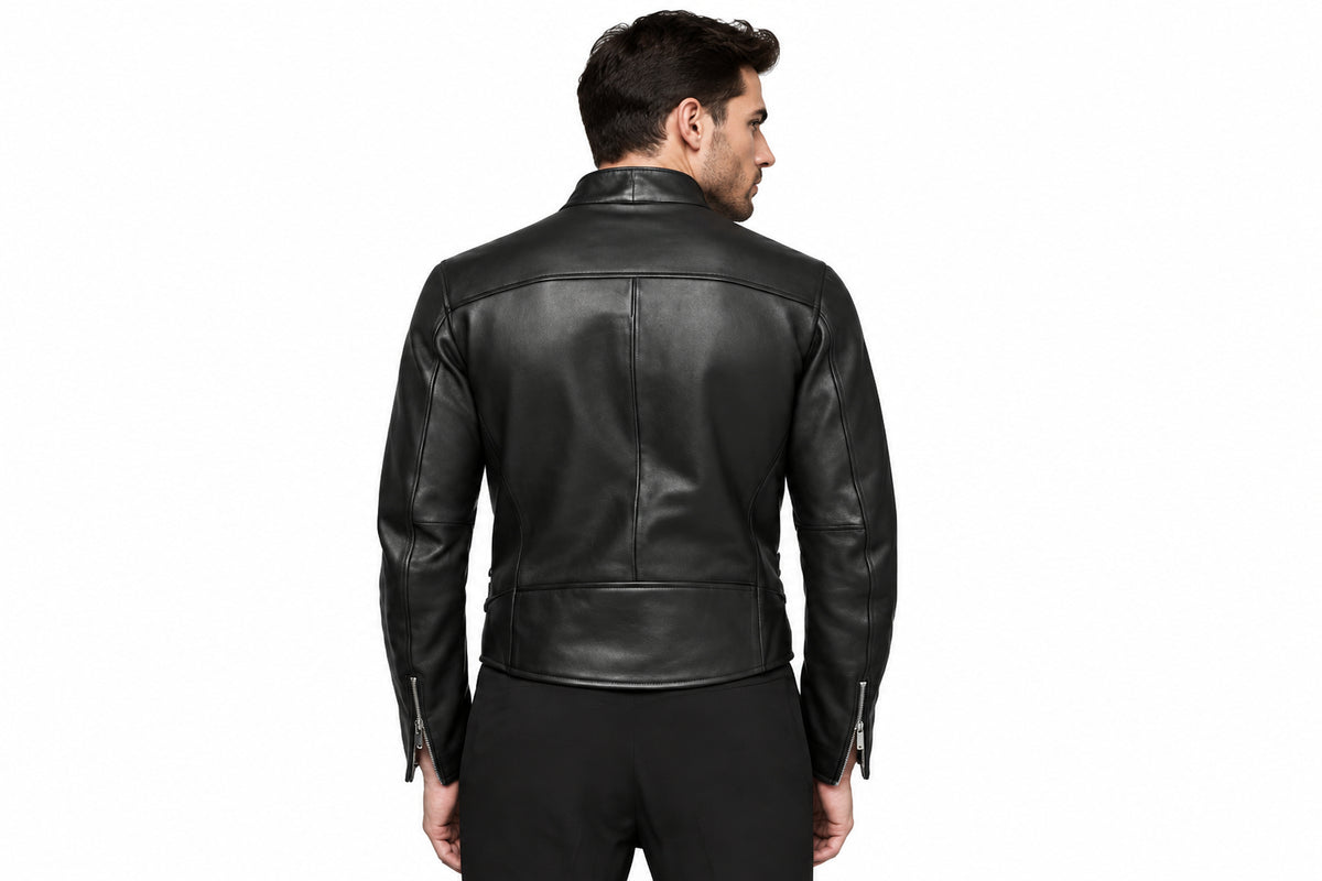 Back view of a man wearing the black The Ironclad Double Rider Jacket featuring an asymmetric stand collar and side buckle details