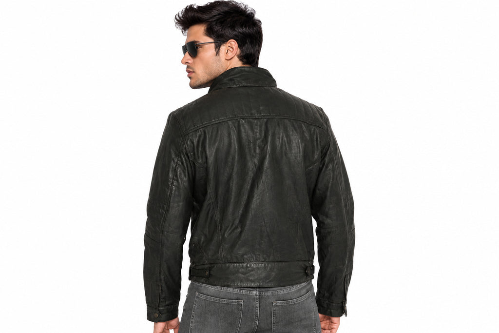 Back view of a man wearing the charcoal black The Monolith Leather Biker Jacket featuring a stand collar and full-zip closure.