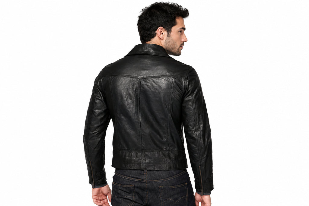 Back view of a man wearing the black The Nightfall Tactical Biker Jacket featuring notched lapels and an asymmetrical zipper.