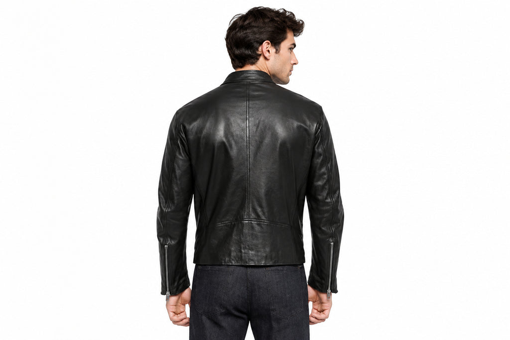 Back view of a man wearing the black The Rebel Moto Icon Leather Jacket featuring a stand collar and vertical zippered chest pockets.