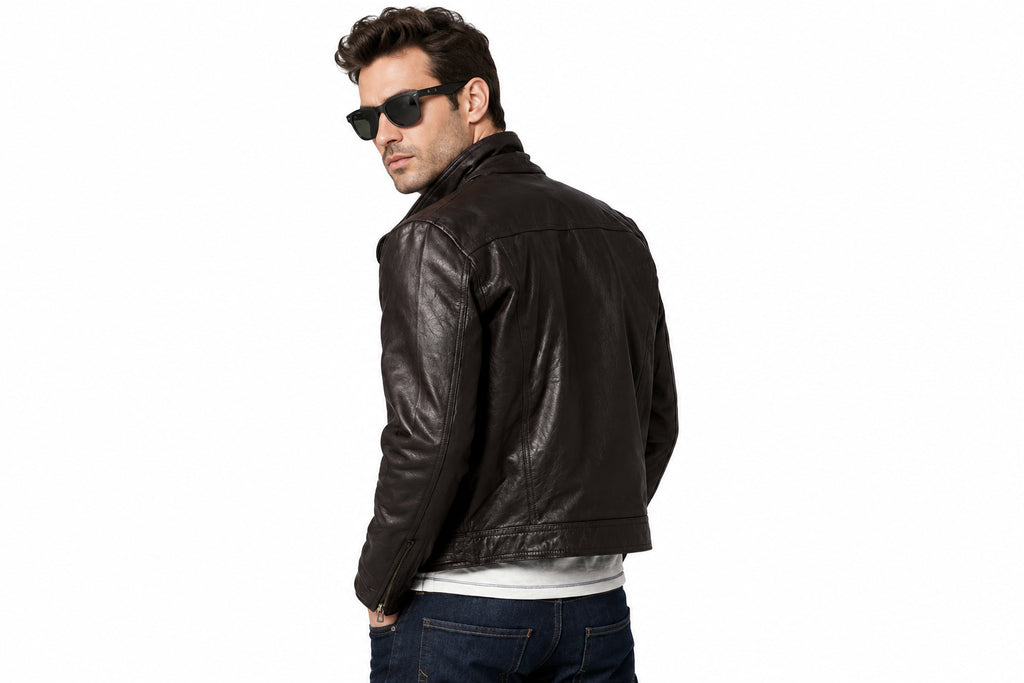 Back view of a man wearing the black The Signature Urban Hide Biker Jacket featuring notched lapels and an asymmetrical zipper.