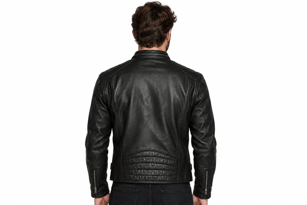 Back view of a man wearing the black The Tailored Outlaw Moto Jacket featuring a stand collar and dual chest zip pockets.