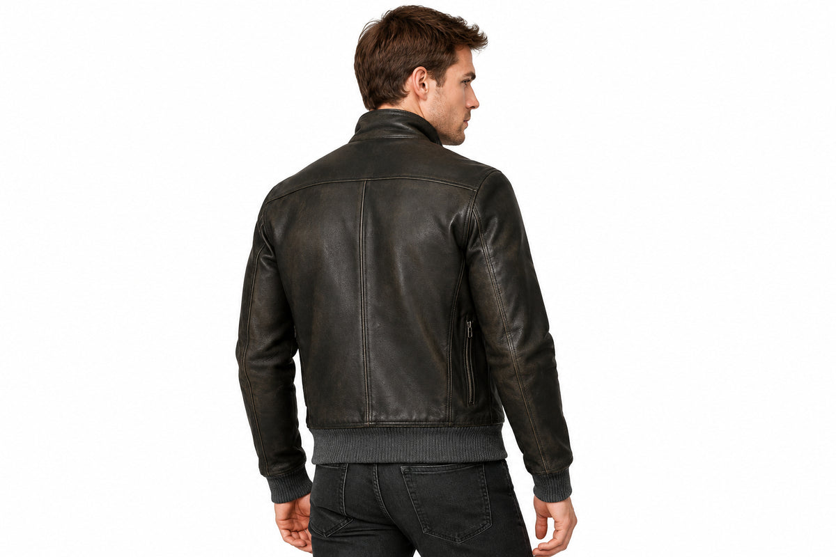 Back view of a man wearing the black The Timberland Vintage Rider Jacket featuring a stand collar and full-zip closure.