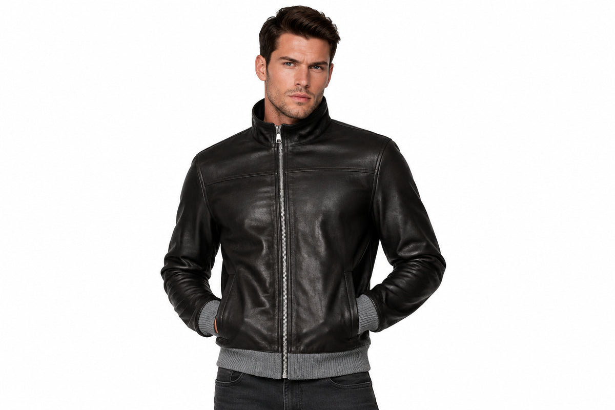 Front view of a man wearing the black The Timberland Vintage Rider Jacket featuring a stand collar and full-zip closure.