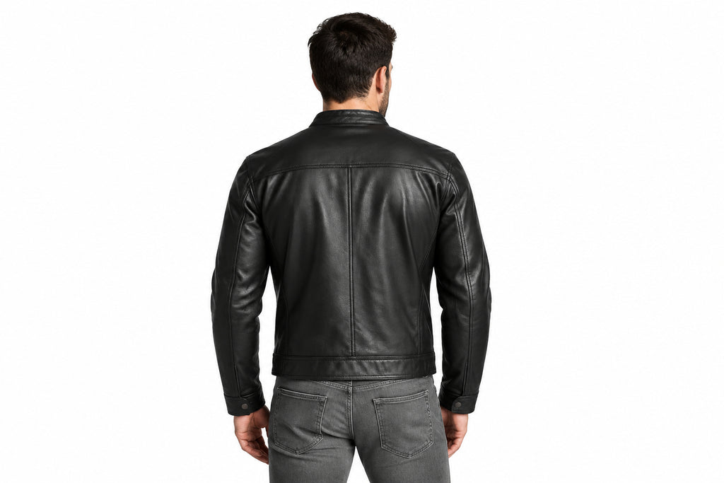 Back view of a man wearing the black The Vantage Belted Moto Jacket featuring a fold-down collar and chest flap pockets.