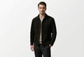 Front view of a man wearing the black Timeless Grain Iconic Suede Leather Jacket featuring dual chest patch pockets and a shirt collar.