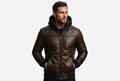 Front view of a man wearing the glossy brown Urban Rogue Nappa Lambskin Leather Bomber Jacket featuring an integrated hood and quilted shoulders.