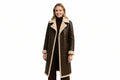 Wild Tempest women's dark espresso brown genuine lambskin leather motorcycle style long coat featuring a plush cream shearling notch collar, exposed shearling-trimmed hem and cuffs, single-breasted four-button closure, and custom made-to-measure fitting across the UK, USA, and Australia.